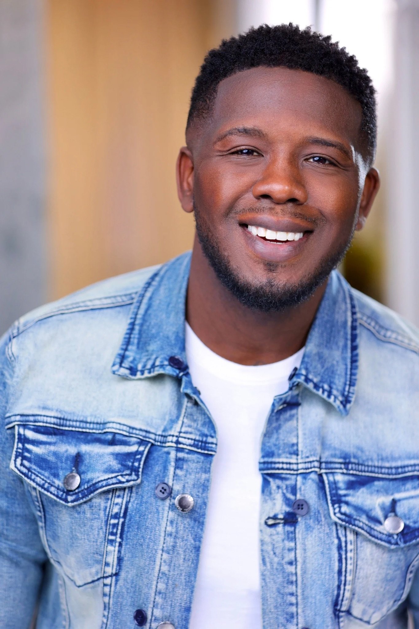Montreal Diggs smiling in a denim jacket