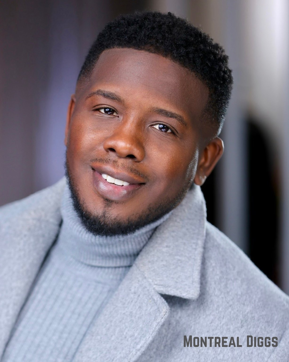 Montreal Diggs in a gray coat and turtleneck