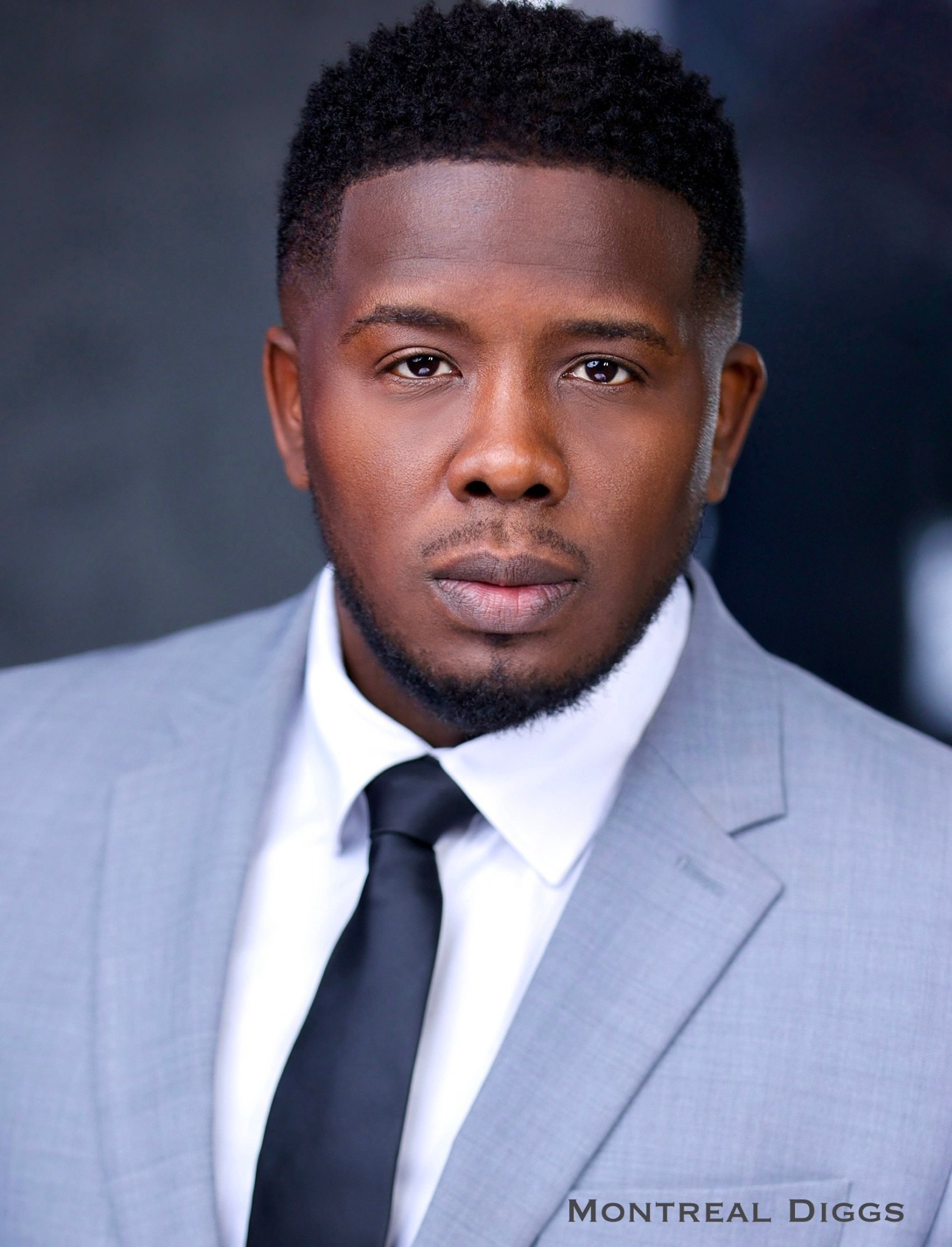 Montreal Diggs in gray suit and black tie